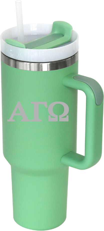 Green travel mug with handle and straw lid, featuring 'ΑΓΩ' text, on a white background
