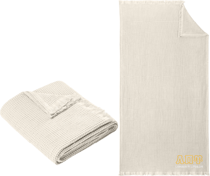 Folded beige blanket next to a larger unfolded beige blanket on a white background