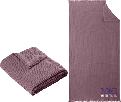 Purple textured blanket with Greek letters on a white background
