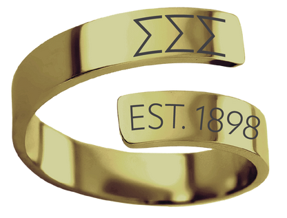 A polished gold open-band ring with engraved dark gray symbols and the text 'EST. 1898' on two small rectangular plates, shown on a plain white background.
