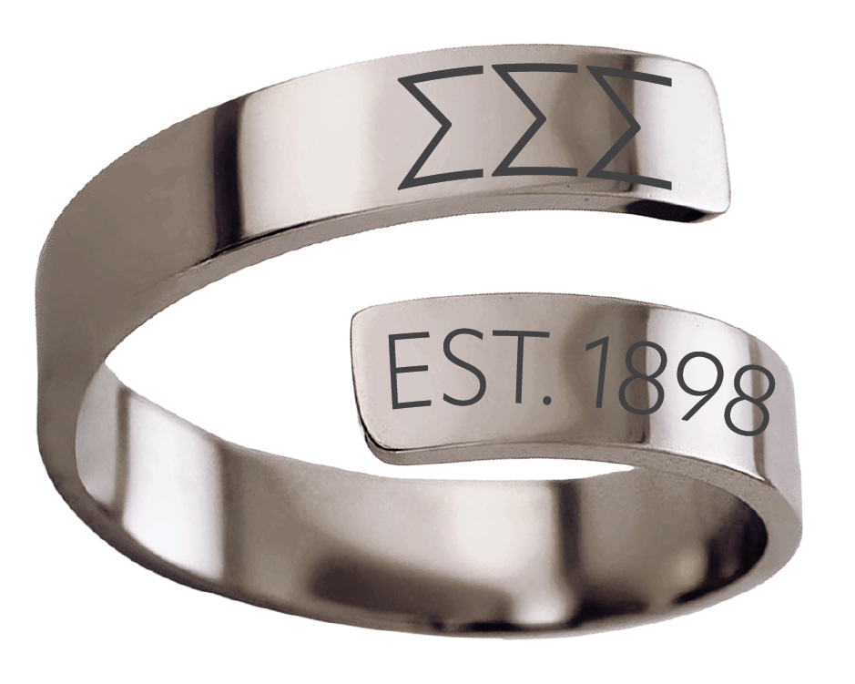 A polished silver-tone open cuff ring engraved with the Greek letters 'ΑΠΛ' and 'EST. 1897' on a clean white background.