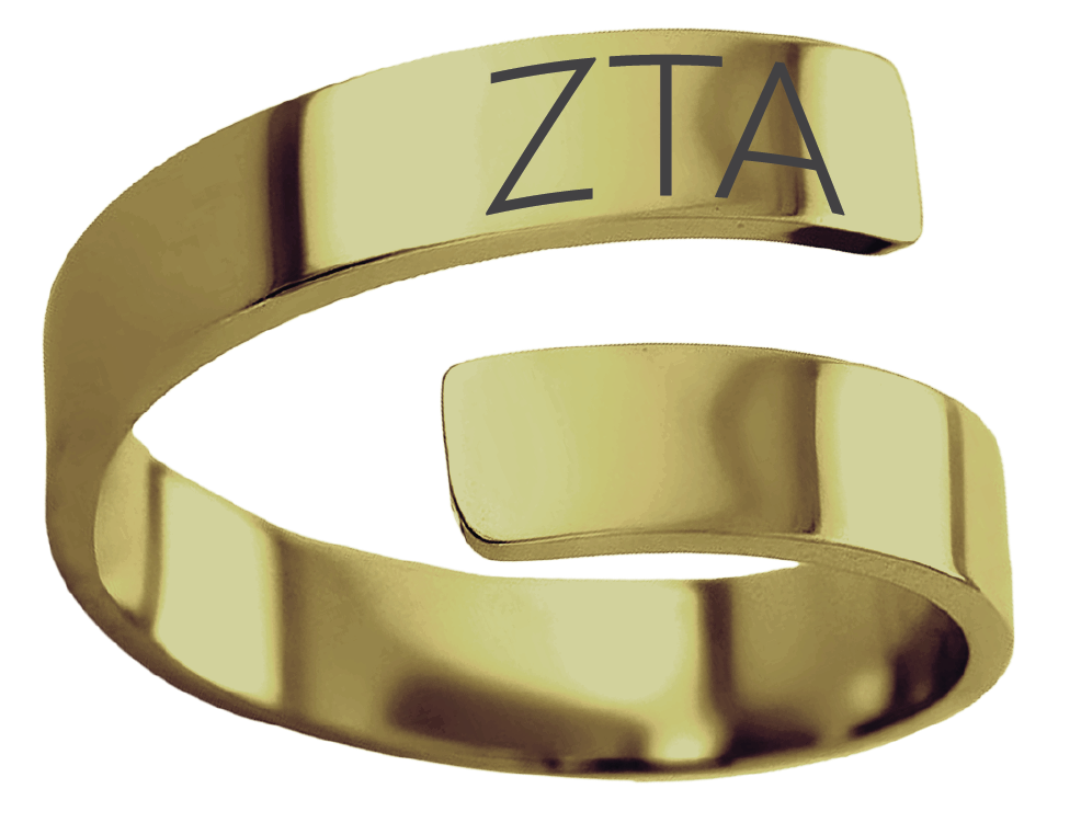 A polished gold open-band ring with the letters 'ZTA' engraved on the top band, shown on a plain white background.
