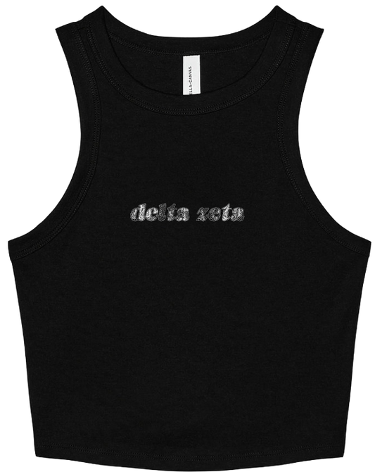 A black sleeveless crop tank top with 'delta zeta' printed across the chest in a textured silver font, shown against a plain white background.