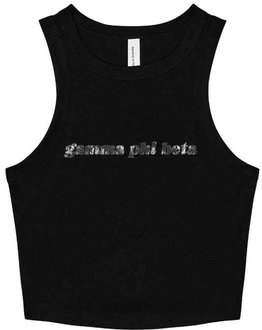 A black sleeveless crop top tank top featuring the text 'gamma phi beta' printed across the chest in a textured silver font. The shirt is displayed flat against a solid white background, with a white neck label visible at the collar.
